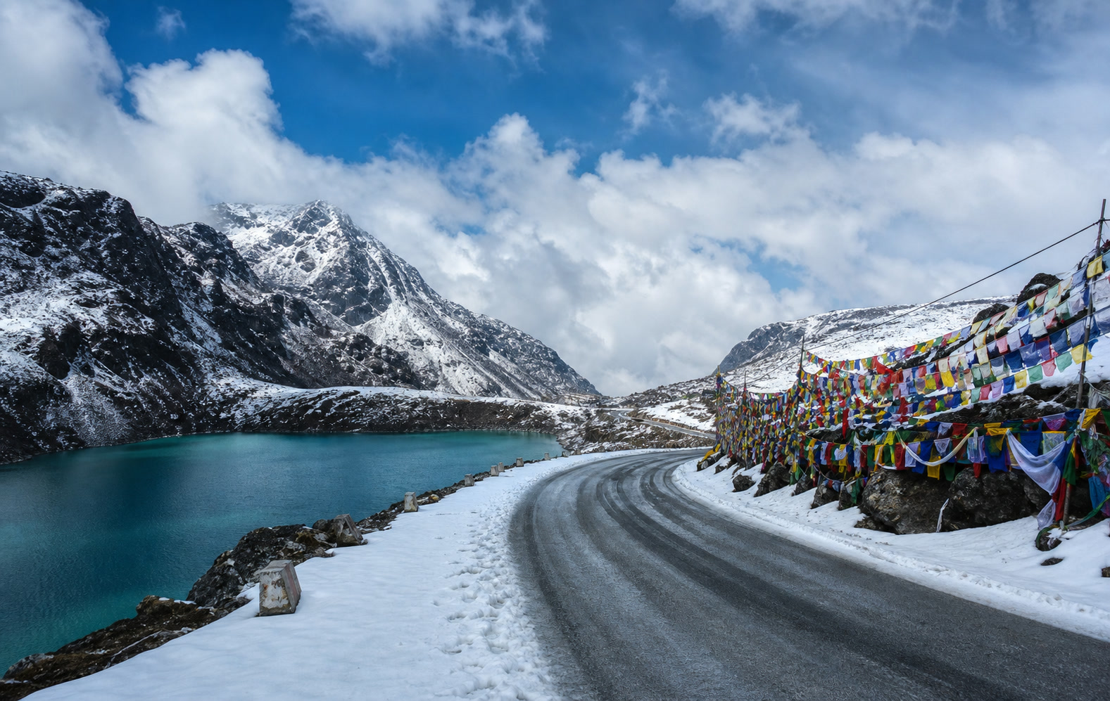 Snowy Sela Pass road and high-altitude lake on the way to Tawang