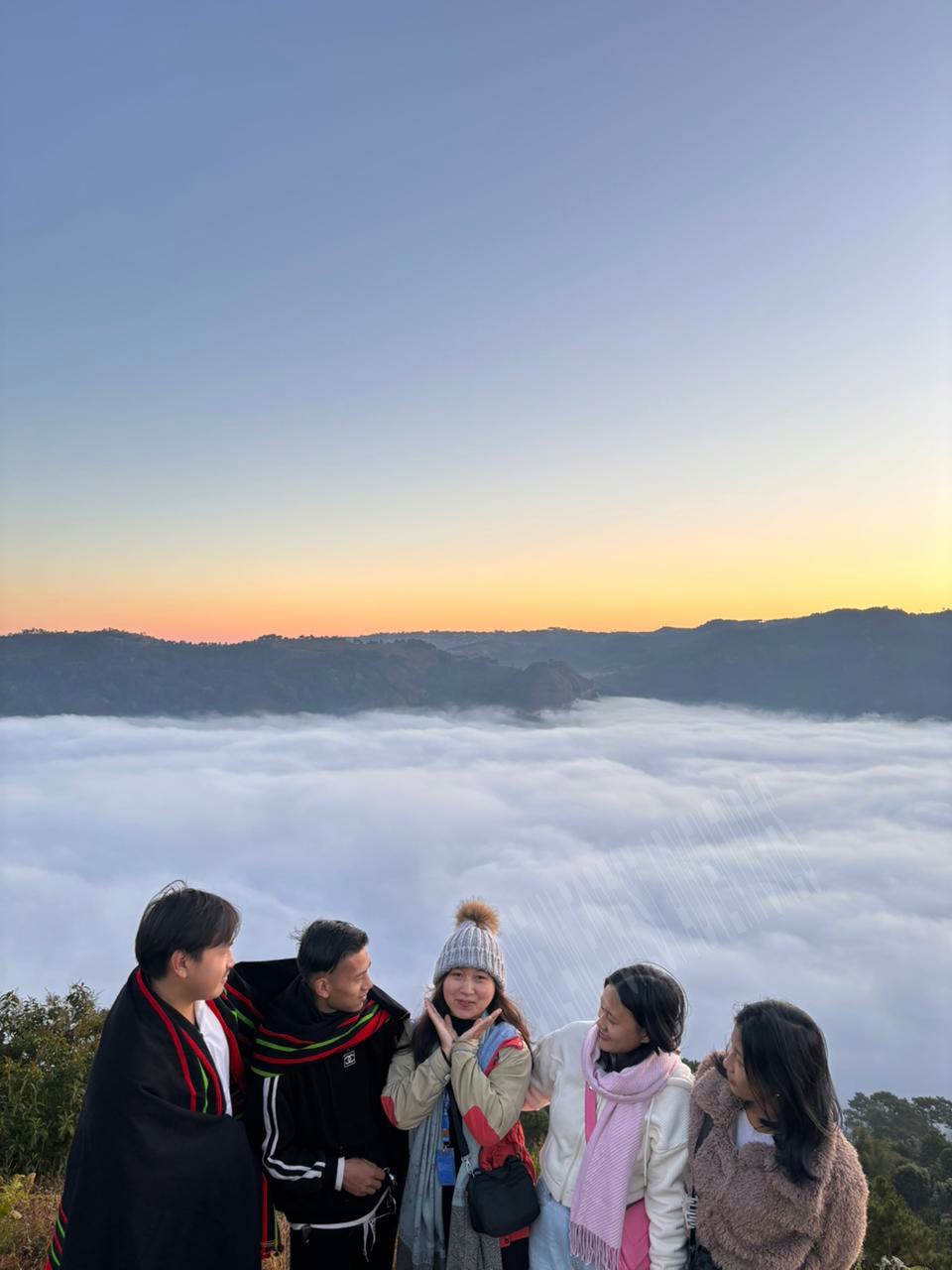 College excursion travelers above the clouds in Meghalaya